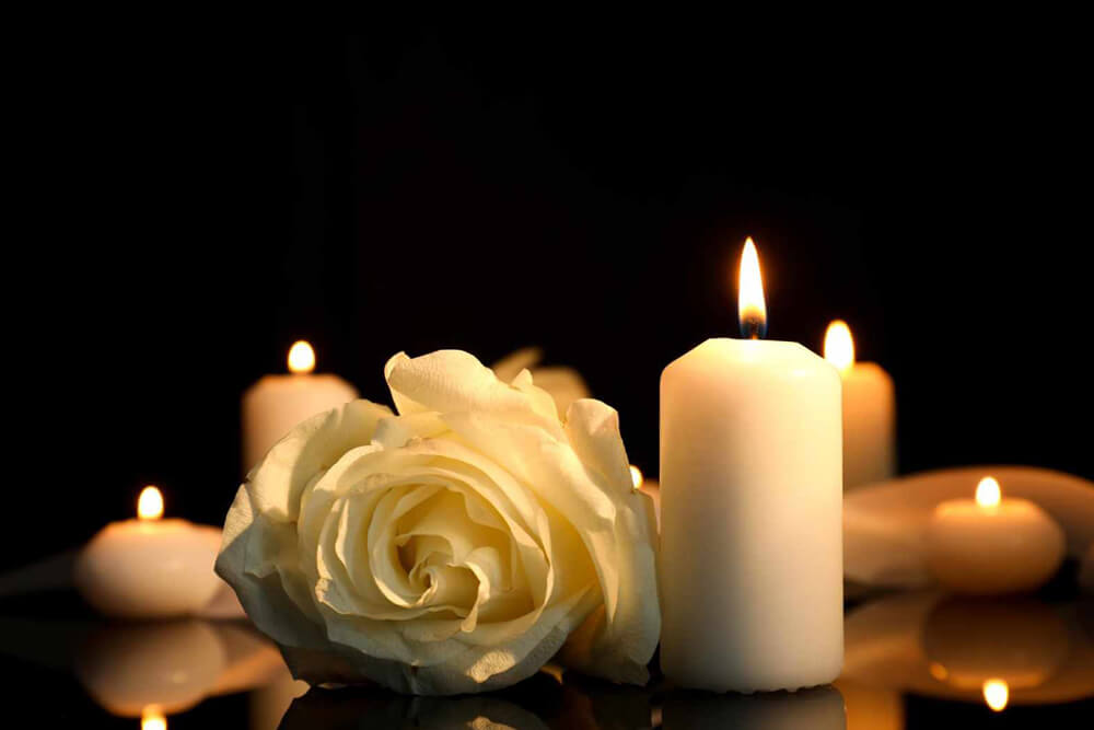 White rose and burning candles